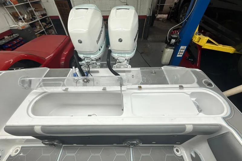 Slide: The Image of 1997 Century 3000 Center Console boat with dual Mercury outboard engines in a garage setting. - 10