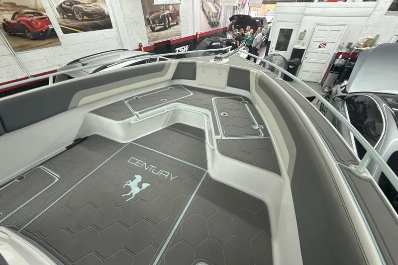 Slide: The Image of 1997 Century 3000 Center Console boat interior with custom flooring in a showroom. - 13