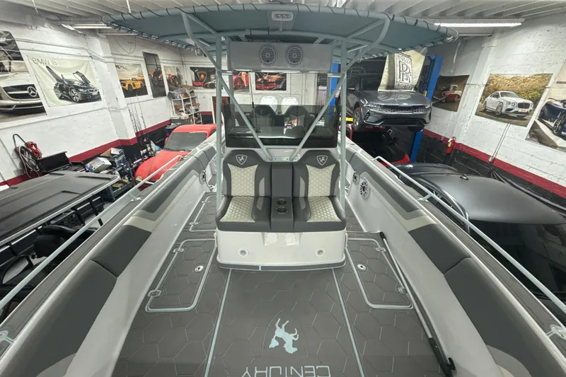 Slide: The Image of 1997 Century 3000 Center Console boat interior in a garage with luxury cars. - 17