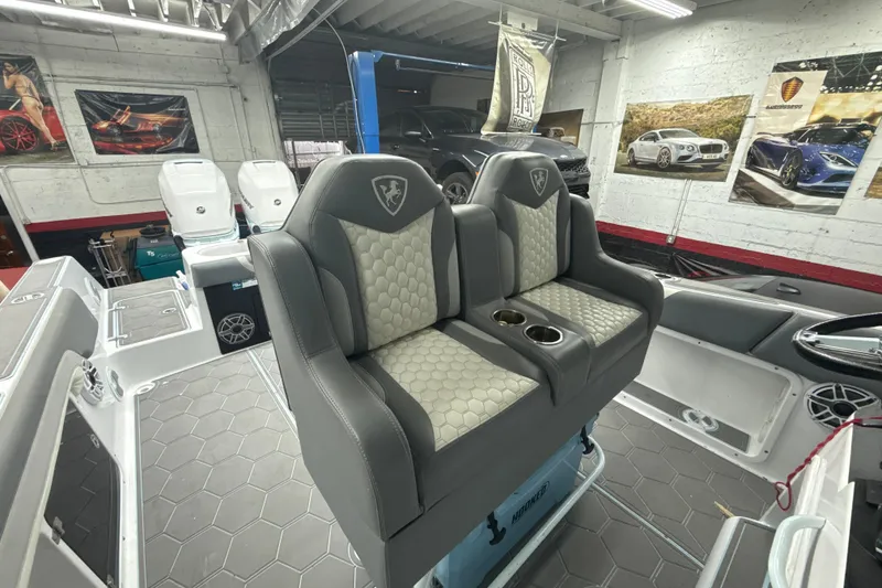 Slide: The Image of Luxurious seating on a 1997 Century 3000 Center Console boat in a modern garage setting. - 22