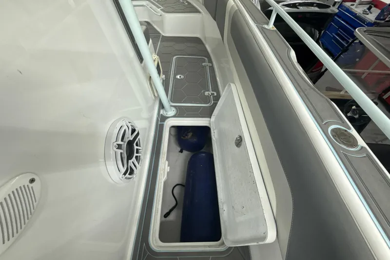 Slide: The Image of 1997 Century 3000 Center Console boat interior with open storage compartment and speaker. - 23