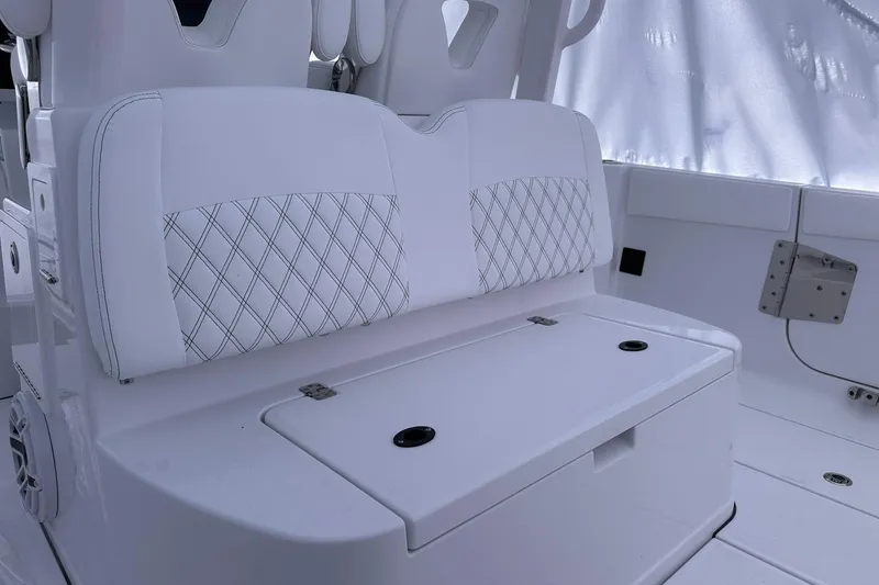 Slide: The Image of 2026 Sportsman Heritage 321 Center Console boat interior with white cushioned seating. - 15