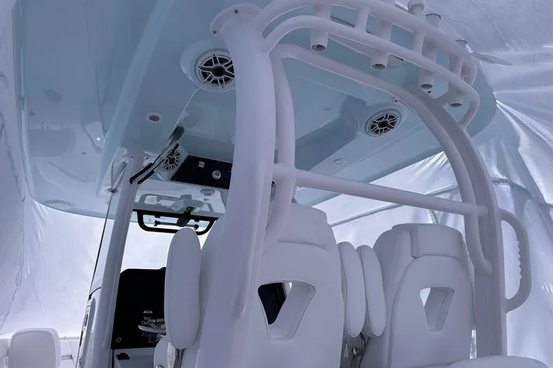 Slide: The Image of 2026 Sportsman Heritage 321 Center Console interior with white seating and overhead speakers. - 16