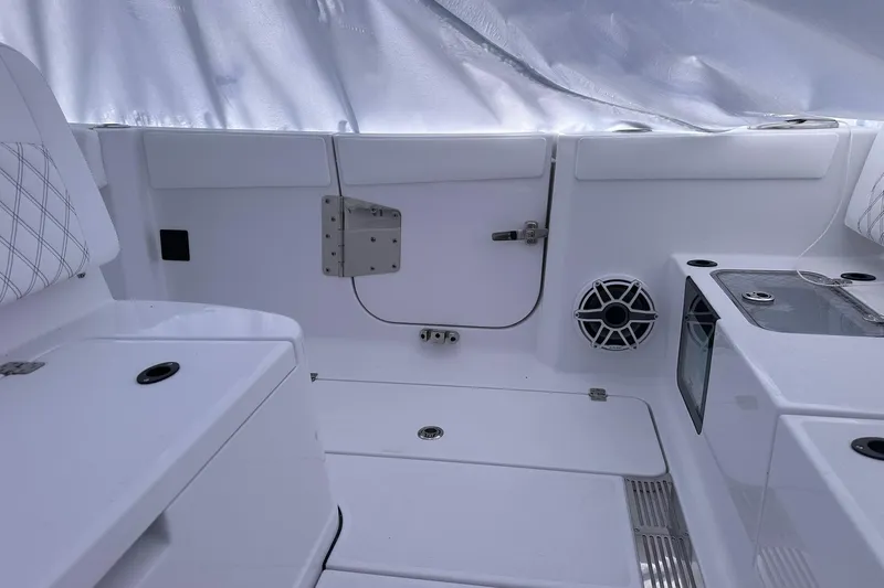 Slide: The Image of Interior of 2026 Sportsman Heritage 321 Center Console boat, featuring sleek white design and speaker. - 17