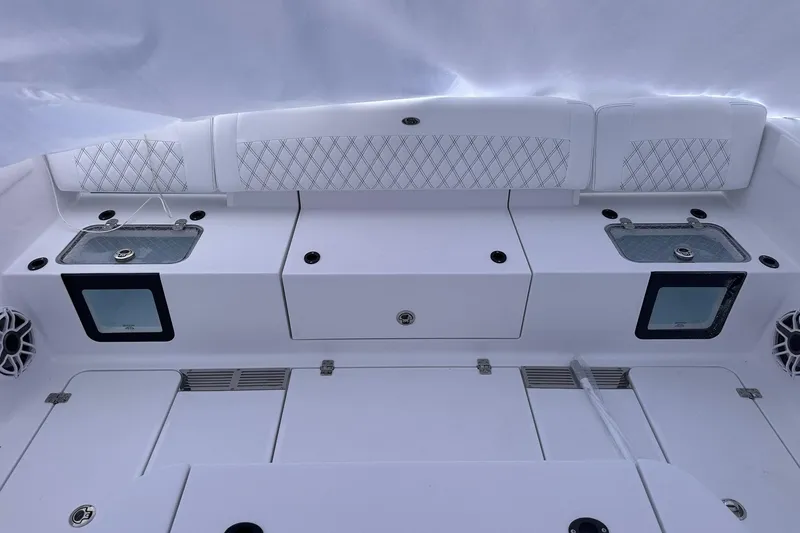 Slide: The Image of 2026 Sportsman Heritage 321 Center Console boat interior with seating and storage compartments. - 22