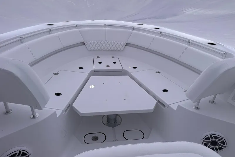 Slide: The Image of 2026 Sportsman Heritage 321 Center Console boat interior with spacious seating and table. - 29