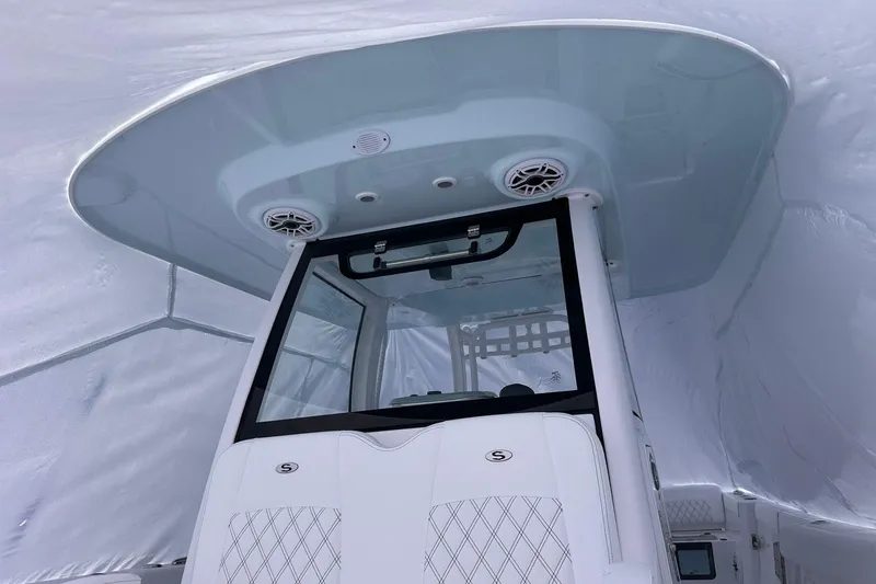 Slide: The Image of 2026 Sportsman Heritage 321 Center Console boat interior with modern design and speakers. - 33