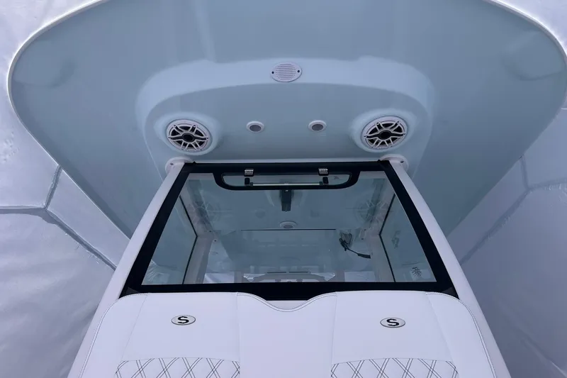 Slide: The Image of 2026 Sportsman Heritage 321 Center Console boat interior with speakers and windshield. - 38