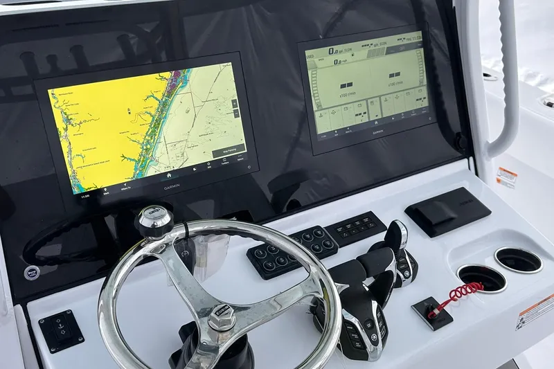 Slide: The Image of 2026 Sportsman Heritage 321 Center Console dashboard with navigation screens and controls. - 43