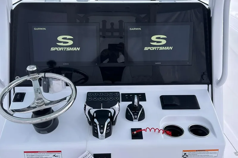 Slide: The Image of 2026 Sportsman Heritage 321 Center Console dashboard with dual Garmin displays and controls. - 45