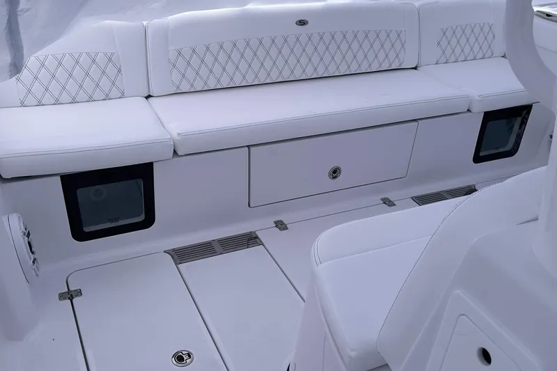 Slide: The Image of 2026 Sportsman Heritage 321 Center Console boat interior with white cushioned seating. - 48