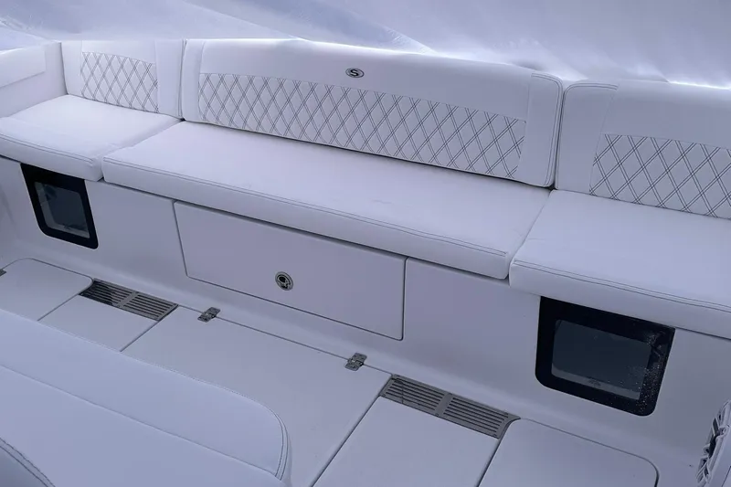 Slide: The Image of 2026 Sportsman Heritage 321 Center Console interior with white cushioned seating. - 50