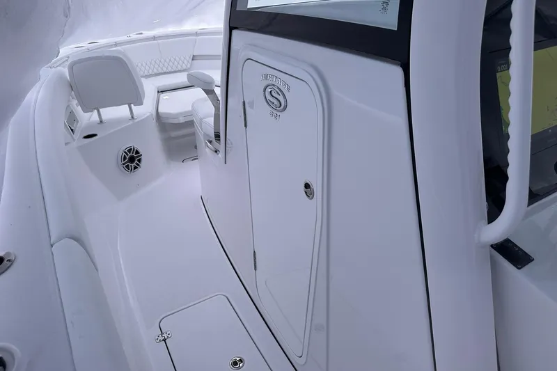 Slide: The Image of 2026 Sportsman Heritage 321 Center Console interior with seating and storage. - 56