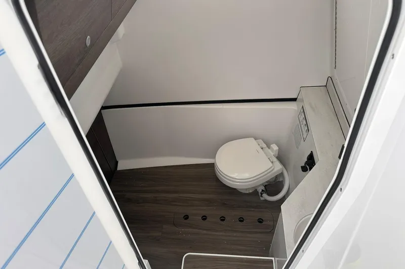 Slide: The Image of 2026 Sportsman Heritage 321 Center Console boat interior bathroom with modern amenities. - 58