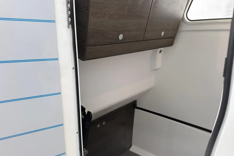 Slide: The Image of Interior view of 2026 Sportsman Heritage 321 Center Console, featuring sleek wooden cabinetry. - 61