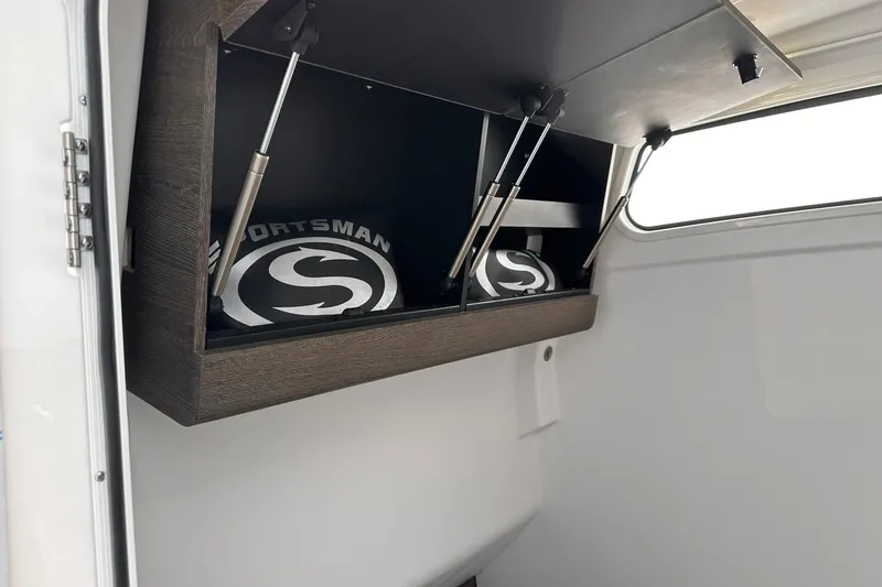Slide: The Image of 2026 Sportsman Heritage 321 Center Console storage compartment with hydraulic lift. - 63