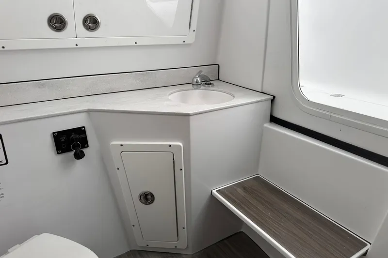 Slide: The Image of 2026 Sportsman Heritage 321 Center Console interior with sink and storage. - 65