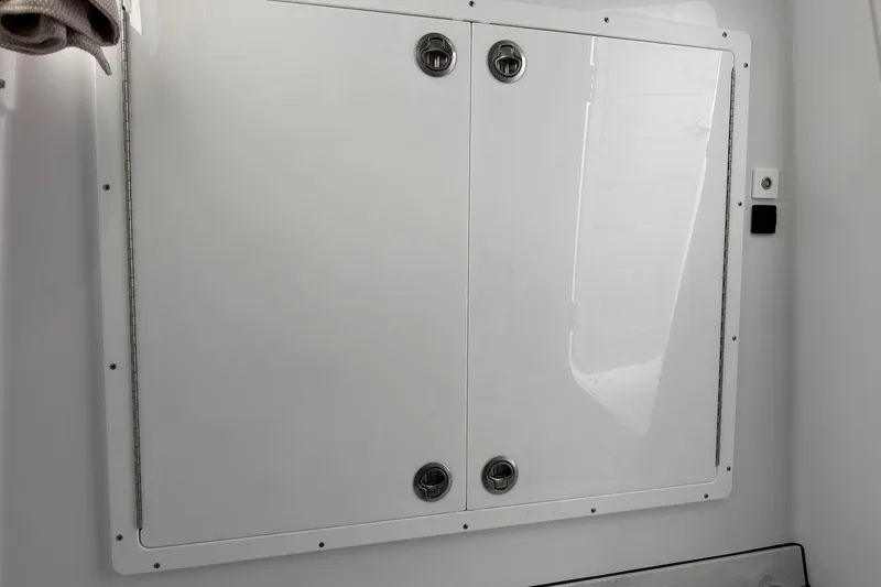 Slide: The Image of 2026 Sportsman Heritage 321 Center Console storage compartment with dual latches. - 66