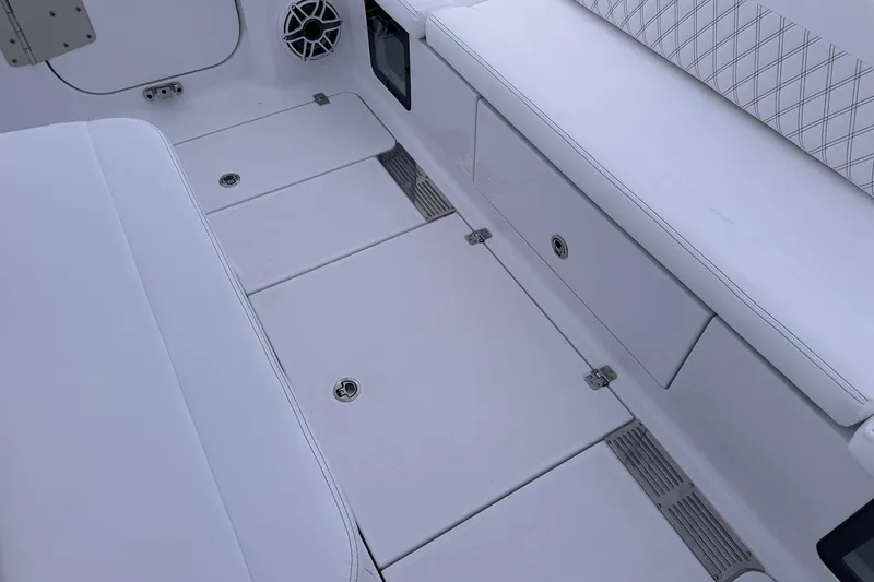 Slide: The Image of 2026 Sportsman Heritage 321 Center Console interior with white seating and storage compartments. - 70