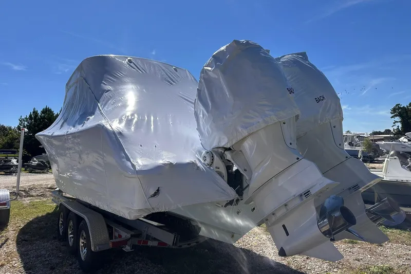 Slide: The Image of 2026 Sportsman Heritage 321 Center Console boat covered, on trailer, with dual outboard motors. - 8