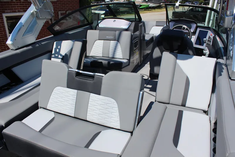 Slide: The Image of 2023 MasterCraft X24 boat interior with luxurious gray and white seating. - 12