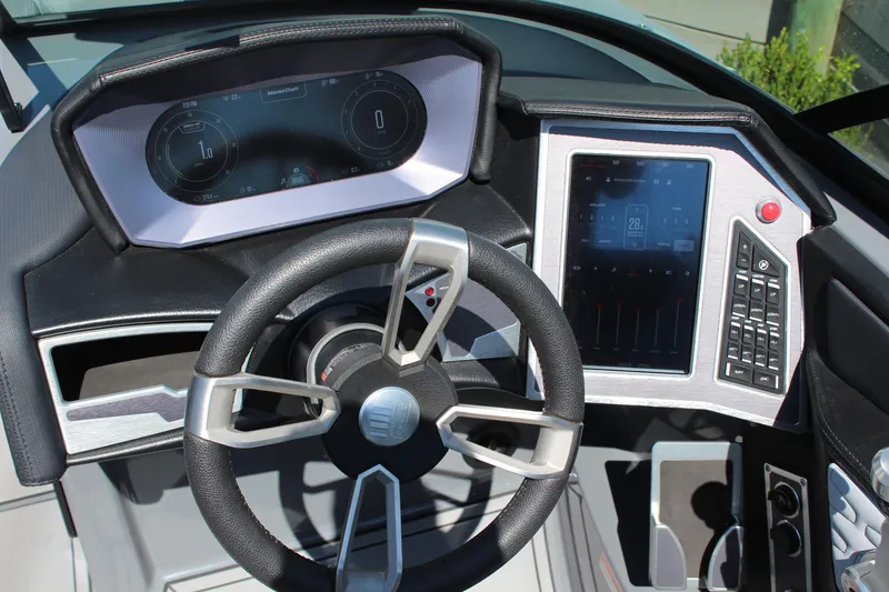 Slide: The Image of 2023 MasterCraft X24 dashboard with modern steering wheel and digital controls. - 16