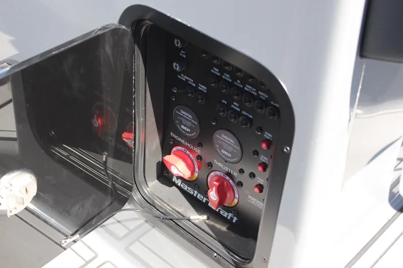 Slide: The Image of Control panel of 2023 MasterCraft X24 boat with switches and dials. - 18