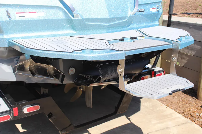 Slide: The Image of 2023 MasterCraft X24 boat rear view with swim platform and propeller. - 20