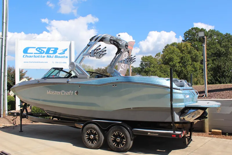 Slide: The Image of 2023 MasterCraft X24 boat on trailer at Charlotte Ski Boats dealership. - 3