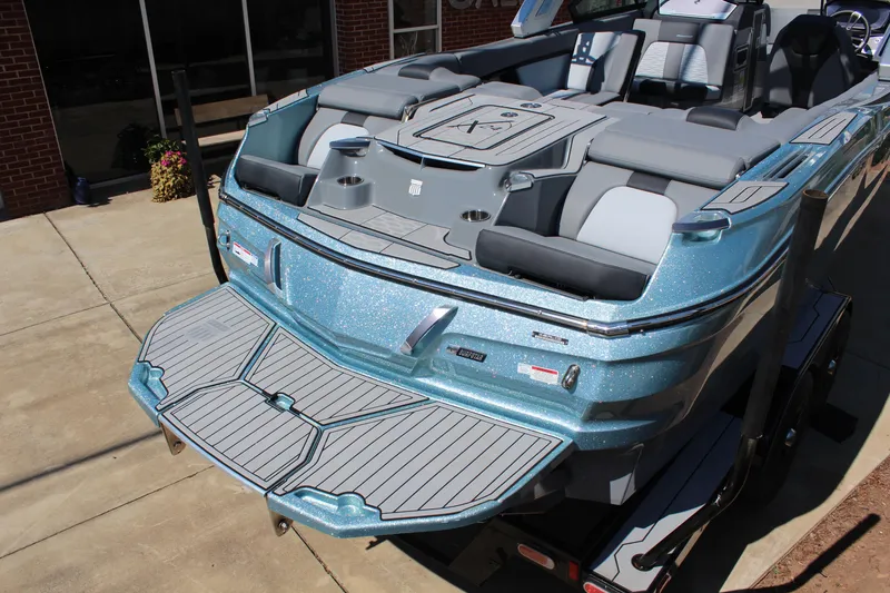 Slide: The Image of 2023 MasterCraft X24 boat with sleek design and spacious seating on a trailer. - 6