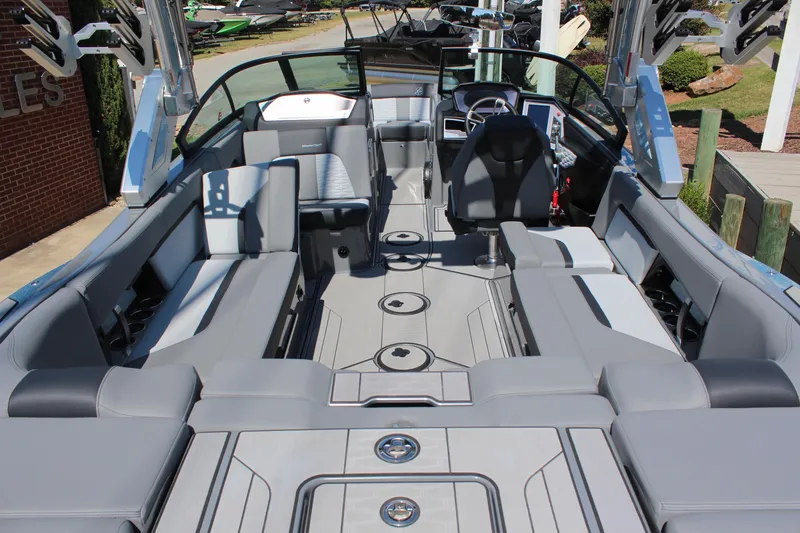 Slide: The Image of 2023 MasterCraft X24 boat interior with luxurious seating and modern dashboard. - 7