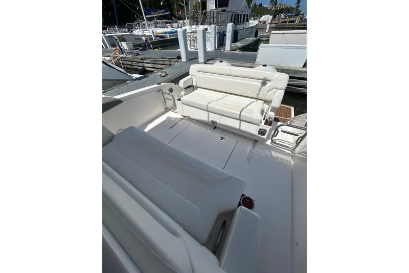 The Image of 2021 Tiara Yachts 34 LS boat interior with white seating at dock. - 1