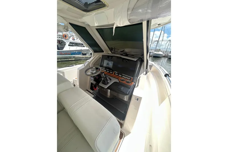 Slide: The Image of 2021 Tiara Yachts 34 LS helm with modern controls and comfortable seating. - 10