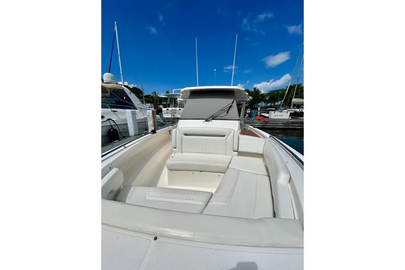 Slide: The Image of 2021 Tiara Yachts 34 LS boat with spacious seating, docked under clear blue sky. - 11