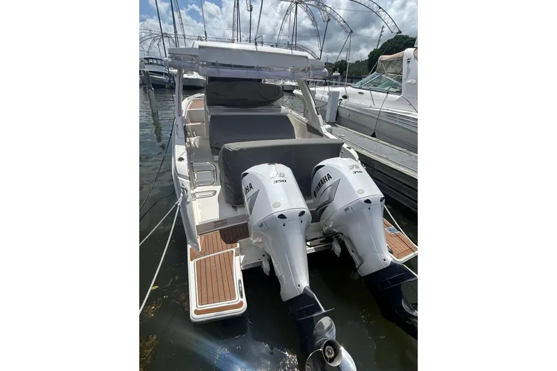 Slide: The Image of 2021 Tiara Yachts 34 LS with twin Yamaha engines docked at marina. - 14