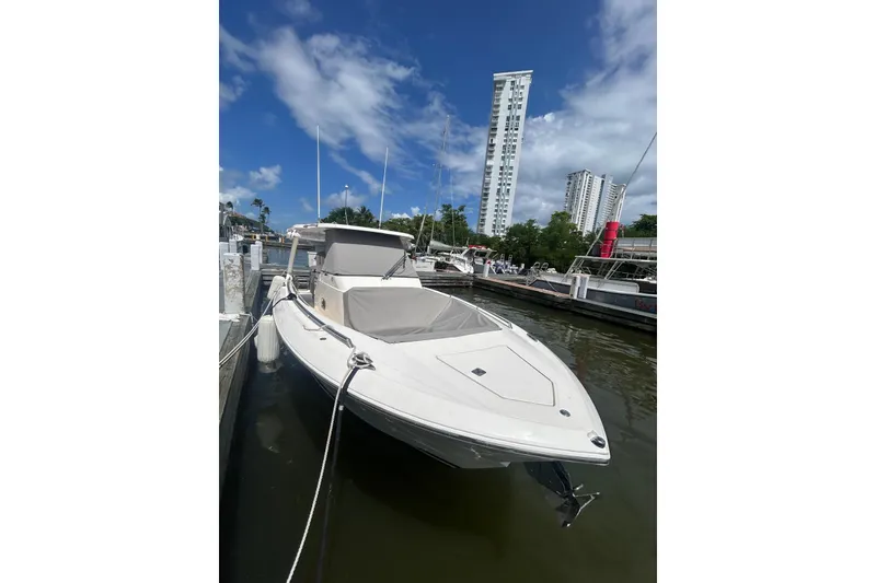 Slide: The Image of 2021 Tiara Yachts 34 LS docked, with cityscape and blue sky background. - 16