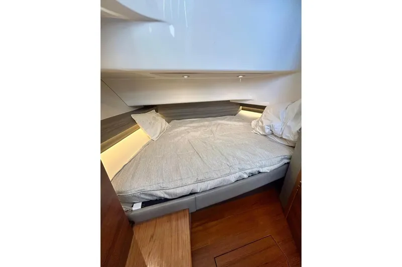 Slide: The Image of 2021 Tiara Yachts 34 LS cabin interior with cozy bed and ambient lighting. - 5