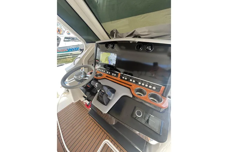 Slide: The Image of 2021 Tiara Yachts 34 LS helm with modern controls and navigation display. - 8