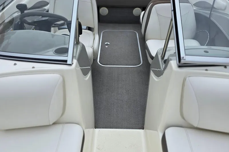 Slide: The Image of Interior view of 2011 Bayliner 180 Bowrider with white seating and gray carpet. - 11