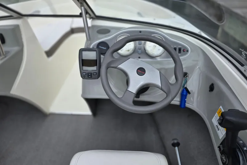 Slide: The Image of 2011 Bayliner 180 Bowrider dashboard with steering wheel and navigation equipment. - 14