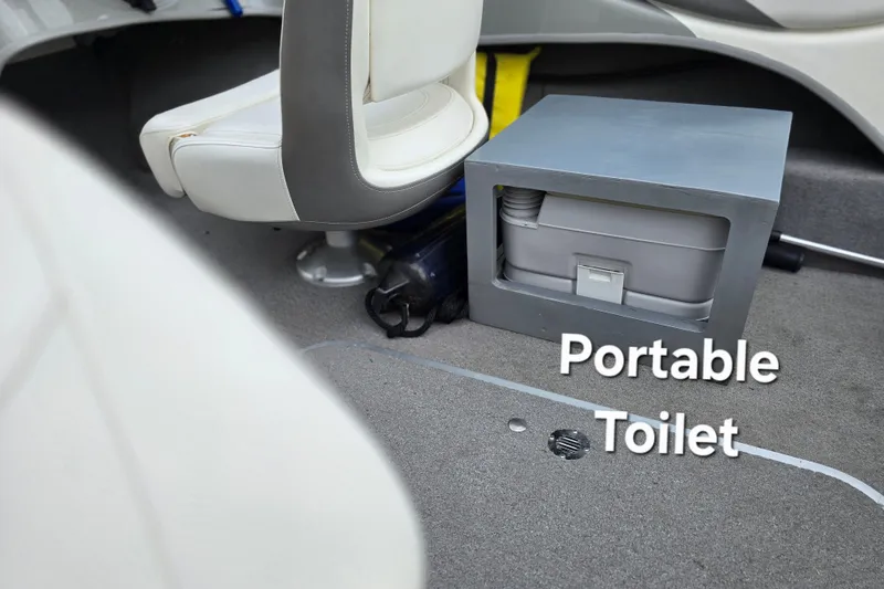 Slide: The Image of 2011 Bayliner 180 Bowrider interior with portable toilet under seat. - 18