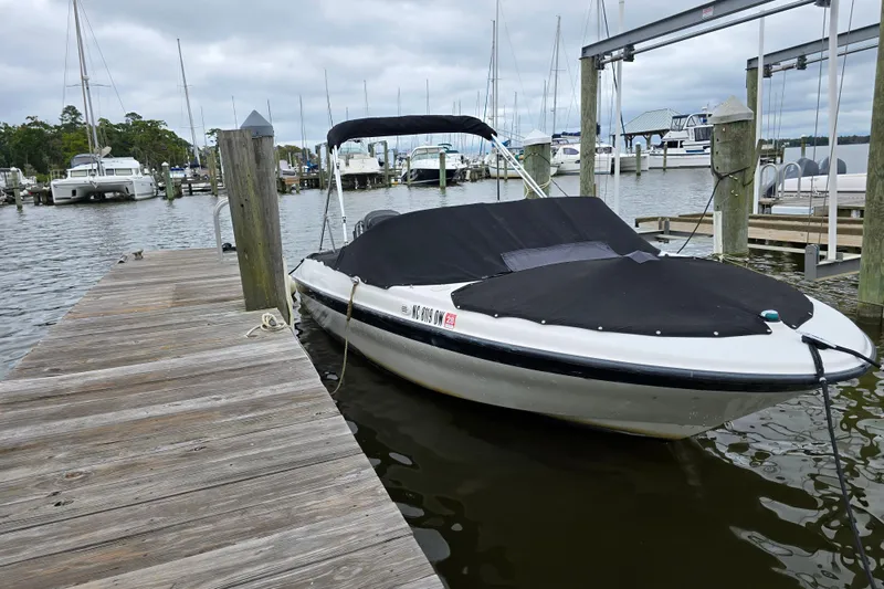 Slide: The Image of 2011 Bayliner 180 Bowrider docked at marina, covered and ready for boating. - 6