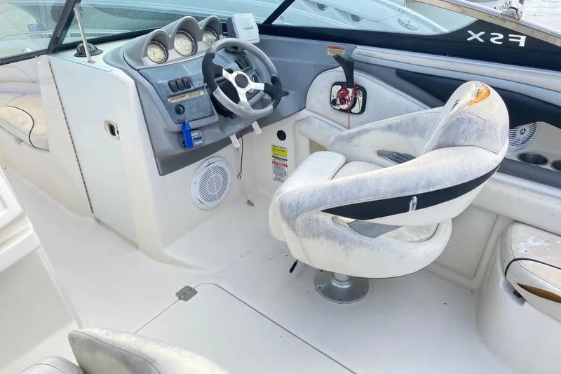 Slide: The Image of 2007 Monterey 234FSX boat interior with steering wheel and control panel. - 11