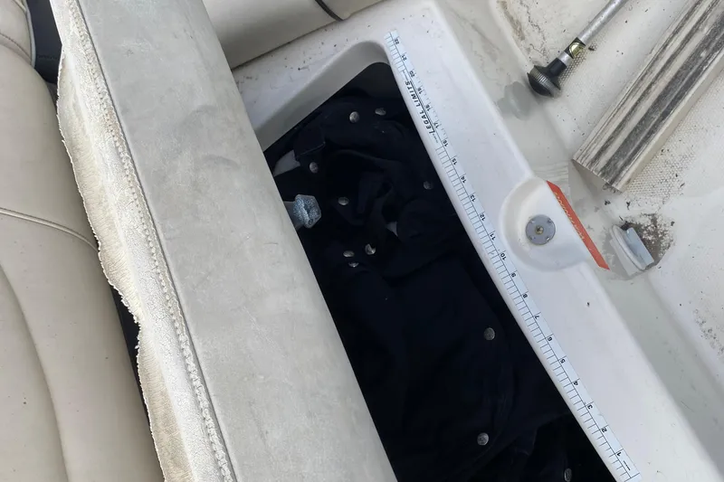 Slide: The Image of 2007 Monterey 234FSX boat interior with storage compartment and measuring scale. - 12