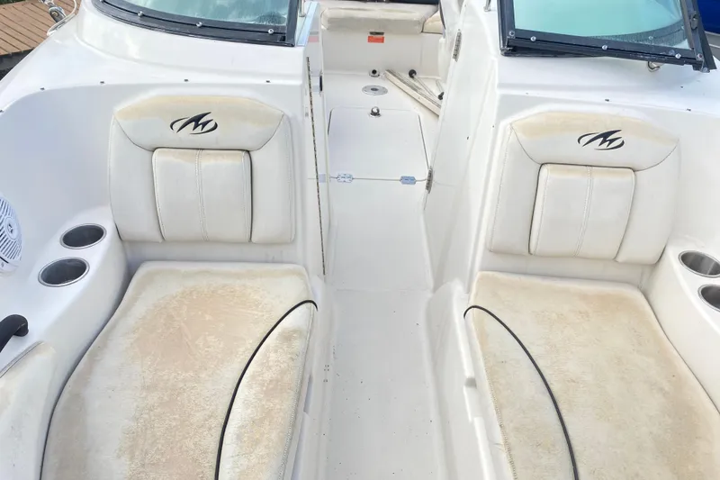 Slide: The Image of 2007 Monterey 234FSX boat interior with white seating and cup holders. - 17