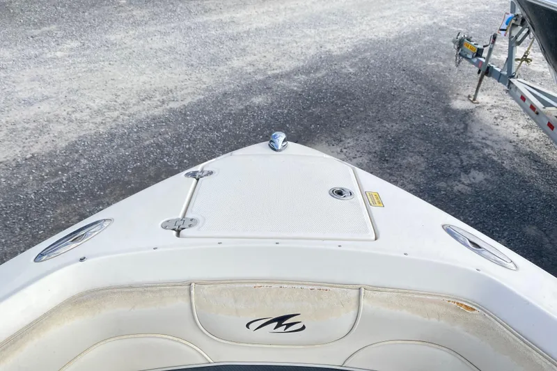Slide: The Image of Bow of a 2007 Monterey 234FSX boat on a gravel surface, near a trailer. - 18