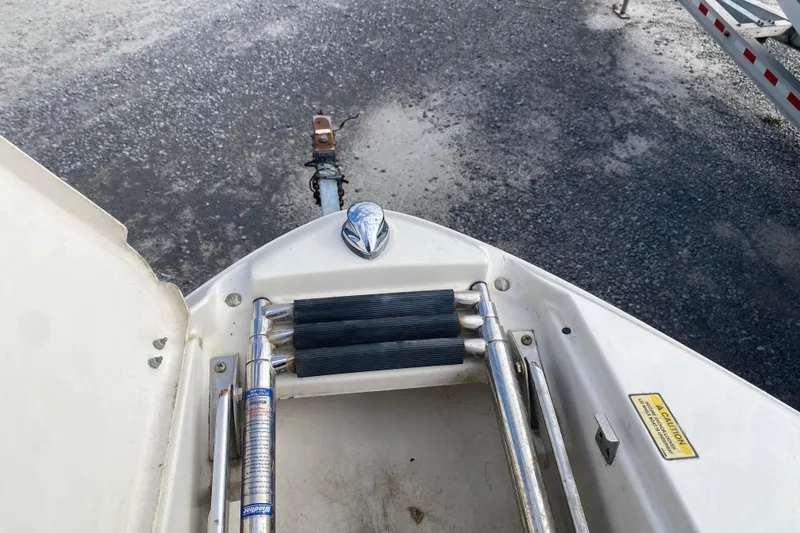 Slide: The Image of 2007 Monterey 234FSX boat ladder and hitch on gravel surface. - 19