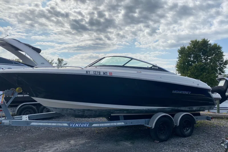 Slide: The Image of 2007 Monterey 234FSX boat on trailer under cloudy sky. - 2