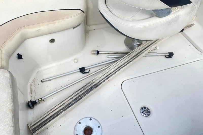 Slide: The Image of 2007 Monterey 234FSX boat interior with scattered metal rods and a swivel seat. - 22