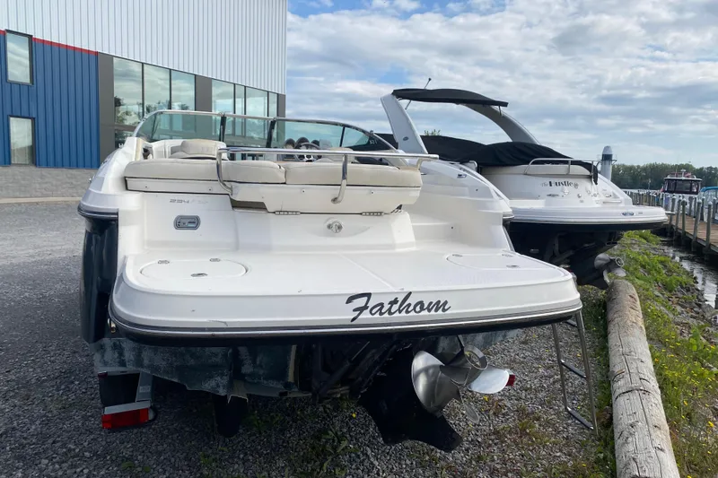 Slide: The Image of 2007 Monterey 234FSX boat named "Fathom" docked near a marina. - 5